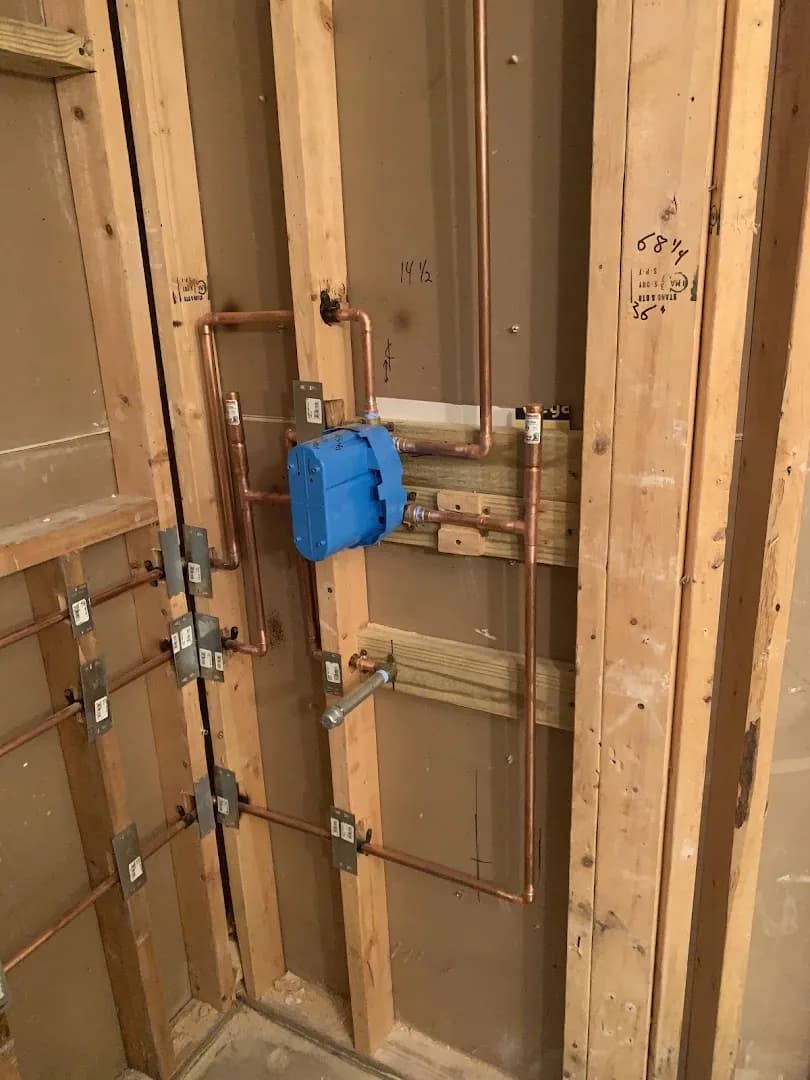 Copper shower-valve rough-in with nail plates in wall framing
